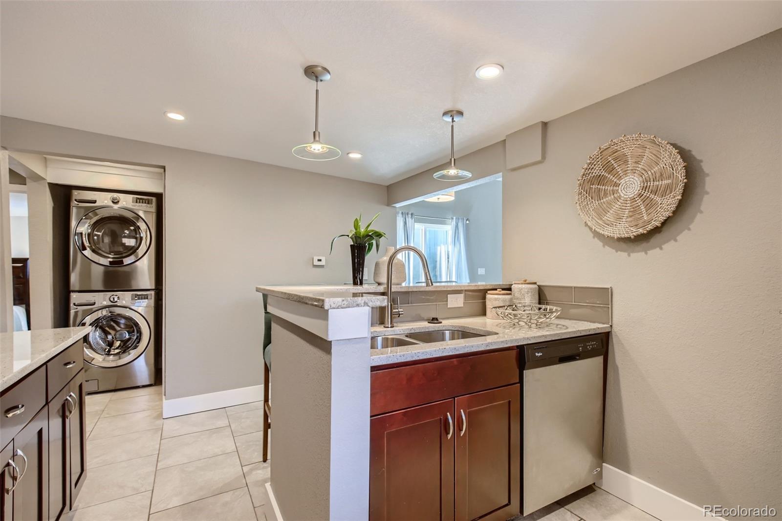 2310 South Decatur Street Denver, CO 80219 - Photo 9 of 27 a kitchen with a sink cabinets and window