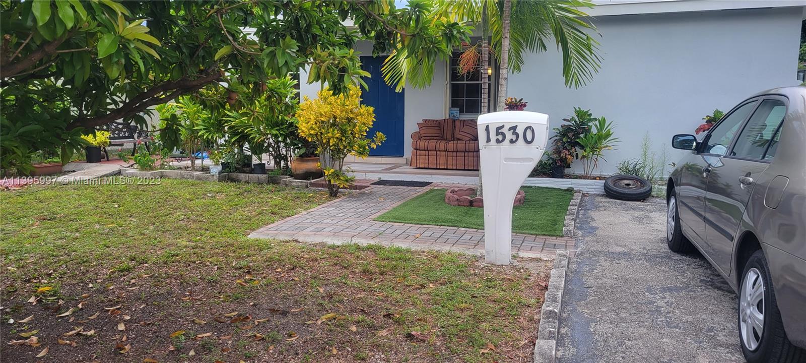 Sunray West North Miami Beach, FL 33162 - Photo 1 of 6 a front view of a house with garden and trees