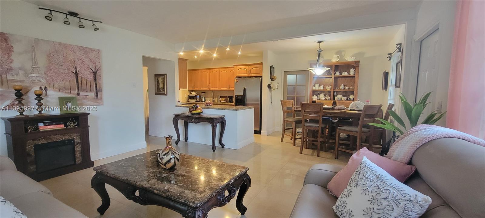 Sunray West North Miami Beach, FL 33162 - Photo 5 of 6 a living room with furniture and a fireplace