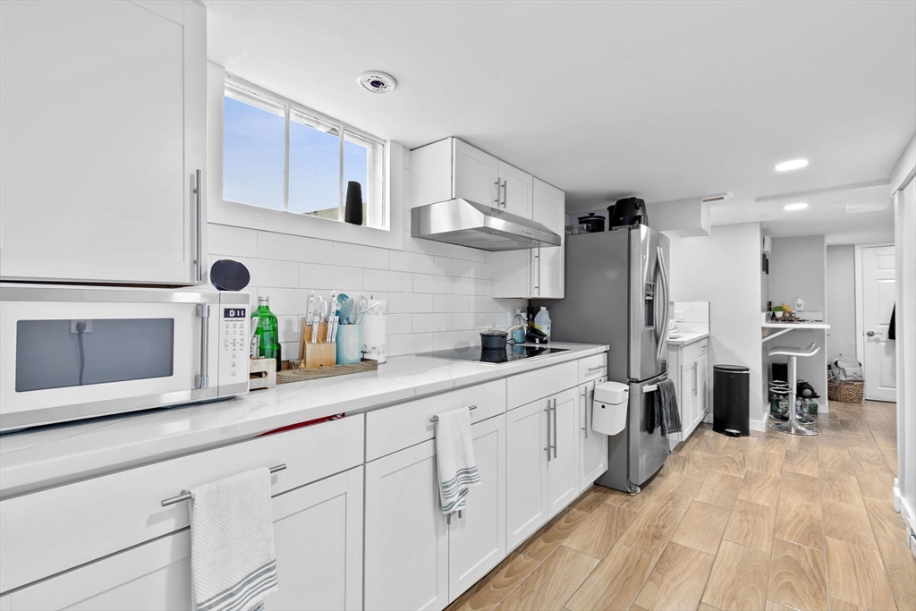 137 Westboro Road North Grafton, MA 01536 - Photo 22 of 36 a kitchen with white cabinets and stainless steel appliances