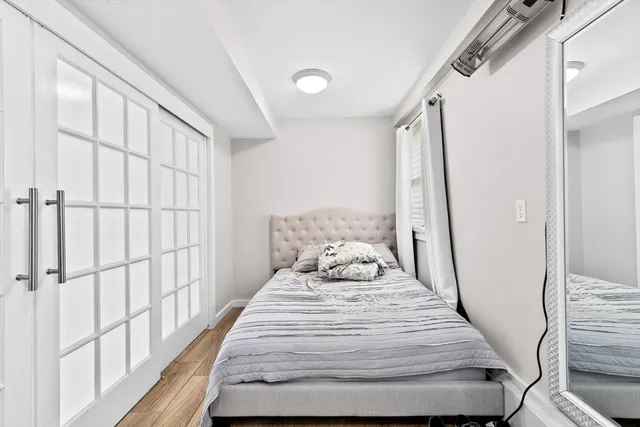 a bedroom with a bed and a large window