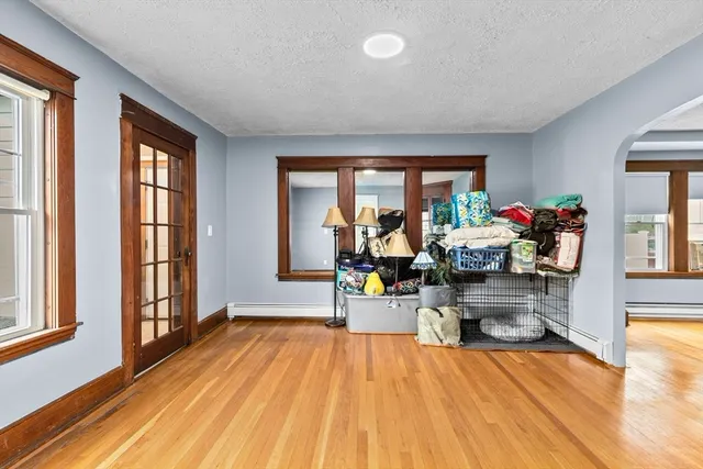 a living room filled with furniture and a wooden floor