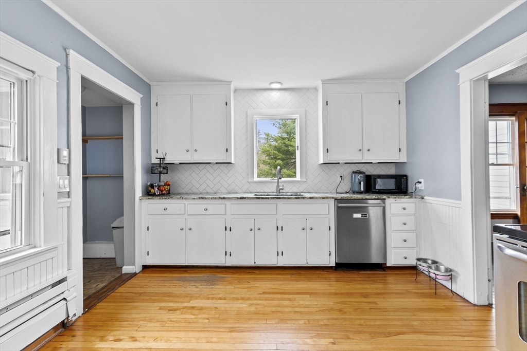 137 Westboro Road North Grafton, MA 01536 - Photo 6 of 36 a kitchen with granite countertop white cabinets and stainless steel appliances