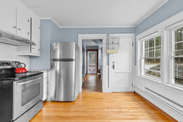 a kitchen with stainless steel appliances granite countertop a refrigerator and a stove