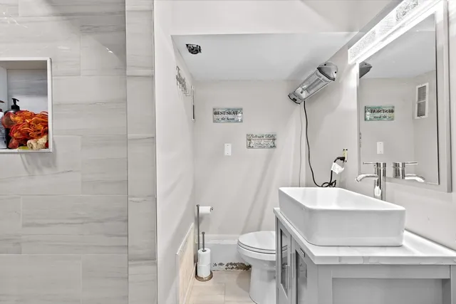 a bathroom with a sink toilet and shower