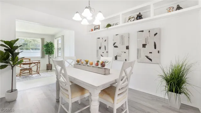 a view of a dining room with furniture and a chandelier