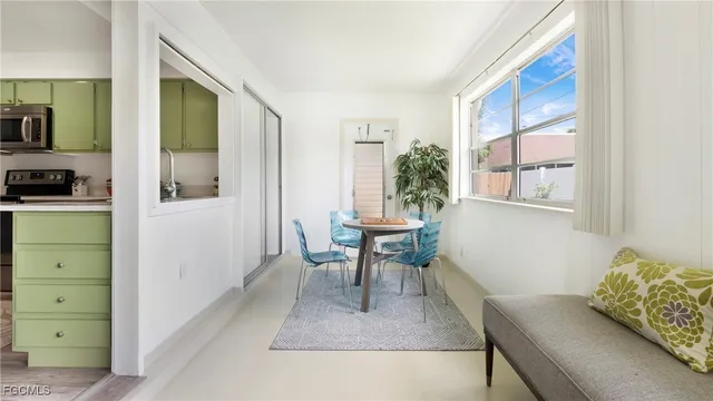 a living room with furniture and a dining table