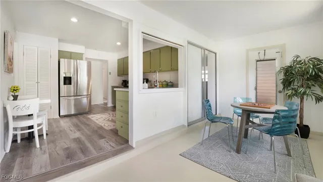 a view of kitchen with furniture and refrigerator