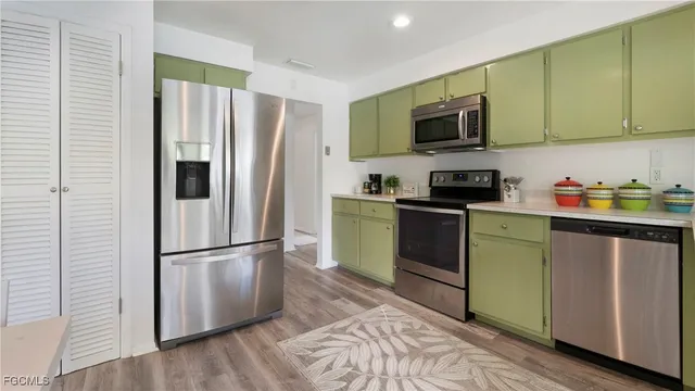 a kitchen with a refrigerator stove and microwave