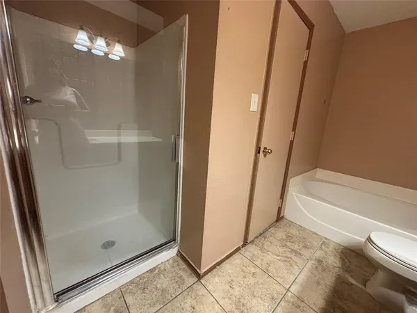 a bathroom with a glass shower door