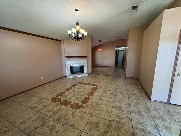 a view of livingroom with kitchen and chandelier