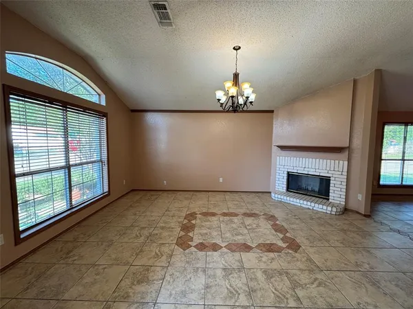 a view of a livingroom with a fireplace and window