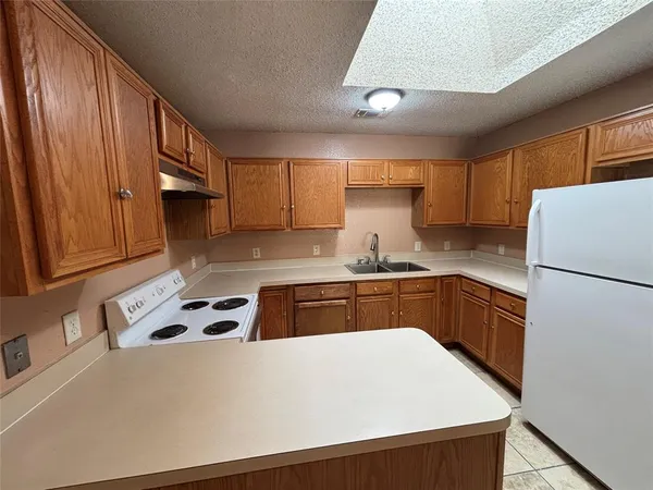 a kitchen with stainless steel appliances a refrigerator sink and cabinets
