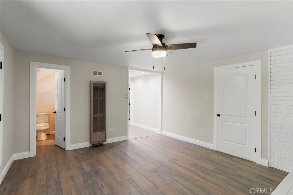 812 Bergschrund Drive Crestline, CA 92325 - Photo 11 of 23 an empty room with wooden floor and ceiling fan