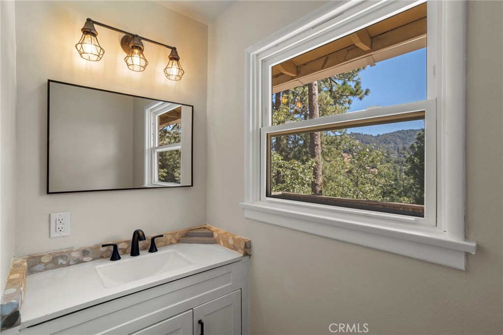 812 Bergschrund Drive Crestline, CA 92325 - Photo 13 of 23 a bathroom with a sink and a mirror
