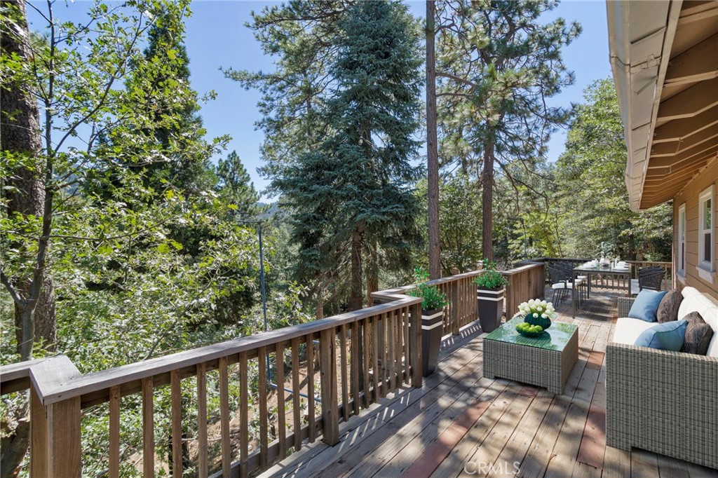 812 Bergschrund Drive Crestline, CA 92325 - Photo 3 of 23 a view of a balcony with couches and wooden fence