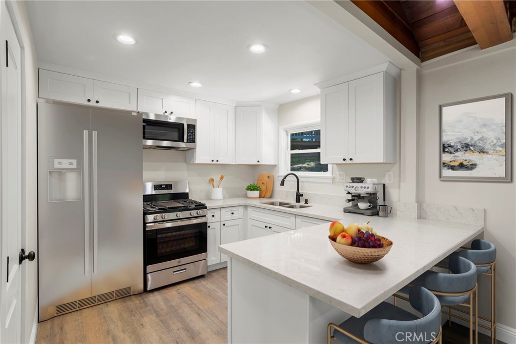 812 Bergschrund Drive Crestline, CA 92325 - Photo 6 of 23 a kitchen with a sink a stove and chairs
