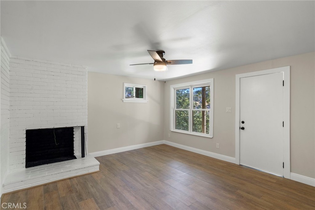 812 Bergschrund Drive Crestline, CA 92325 - Photo 10 of 23 a view of an empty room with wooden floor and a window