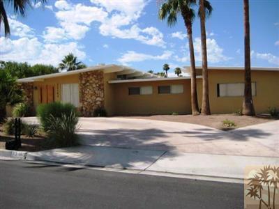 72140 Rancho Road Rancho Mirage, CA 92270 - Photo 4 of 13 a front view of a house with a garden