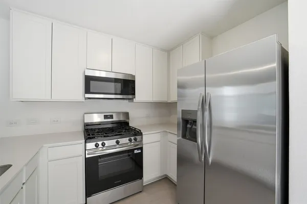 a kitchen with a refrigerator stove and microwave