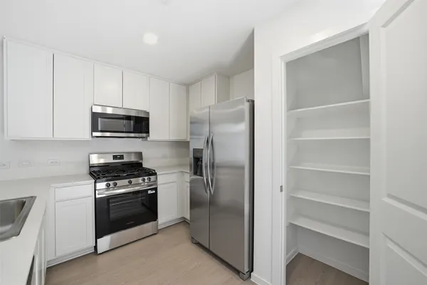 a kitchen with a refrigerator stove and microwave