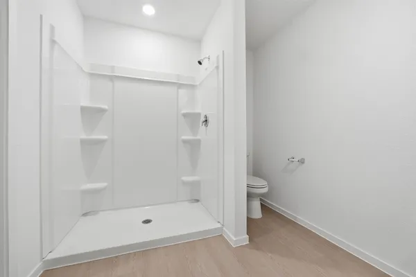 a bathroom with a shower and a glass door