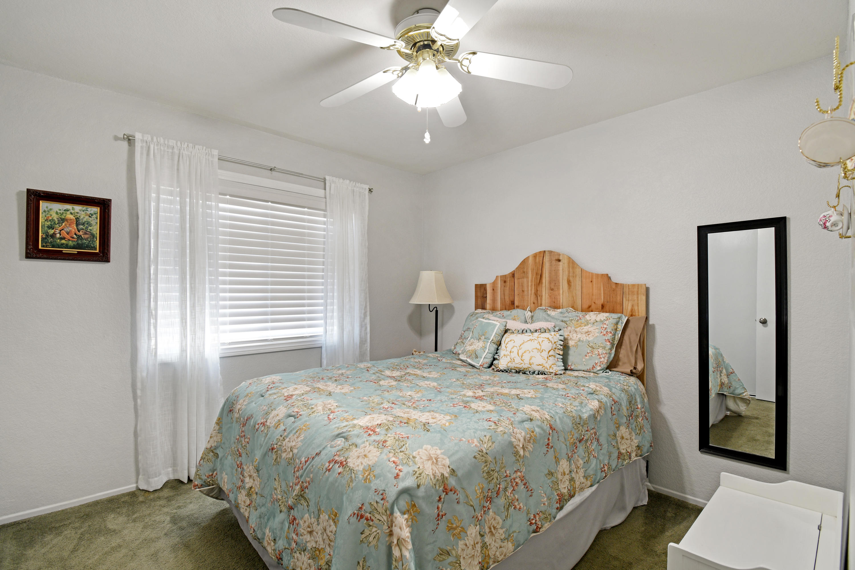 3129 Quarry Road Palmdale, CA 93550 - Photo 12 of 19 a bedroom with a bed and a chandelier
