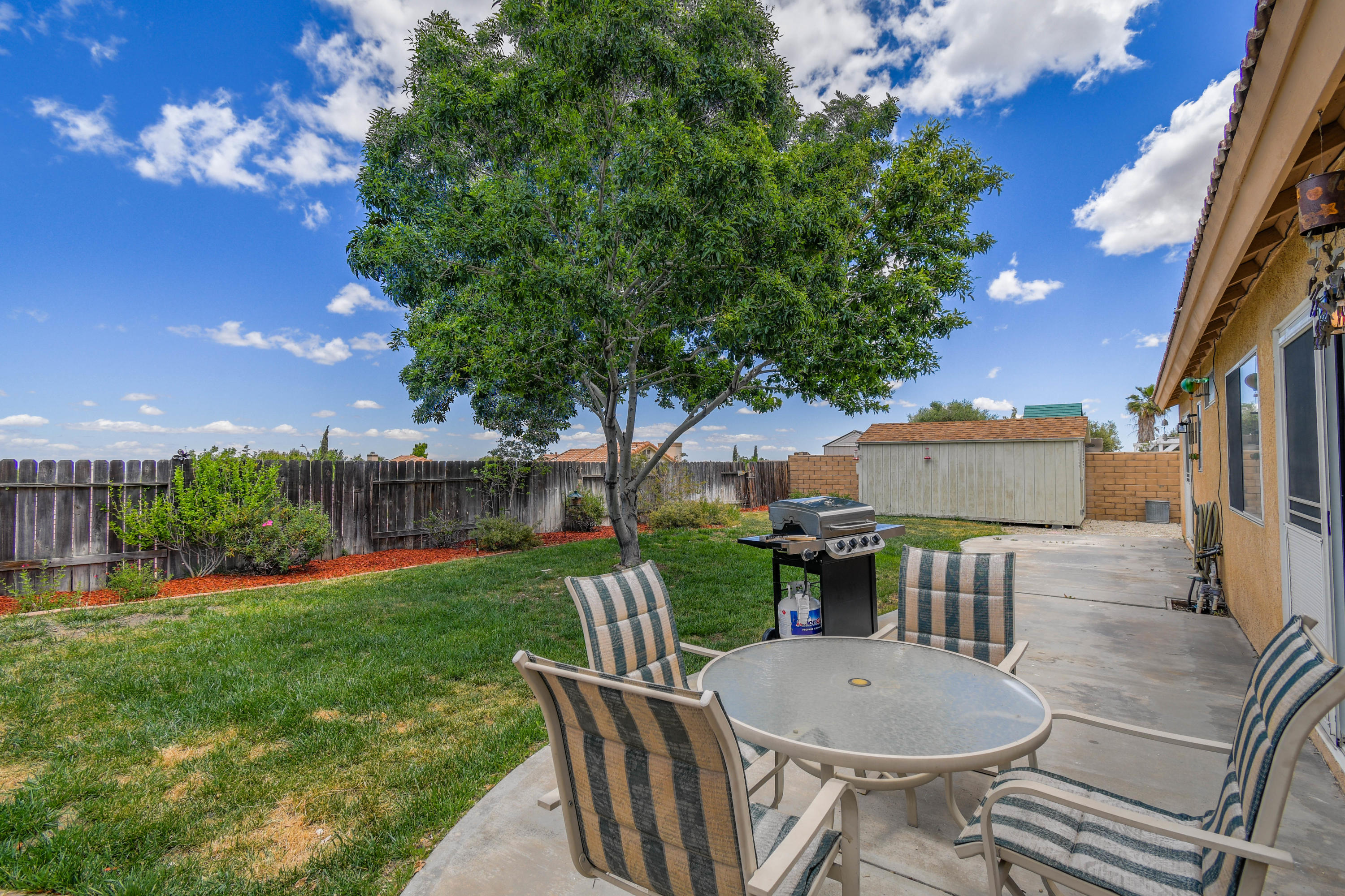 3129 Quarry Road Palmdale, CA 93550 - Photo 15 of 19 a view of a porch with furniture and a yard