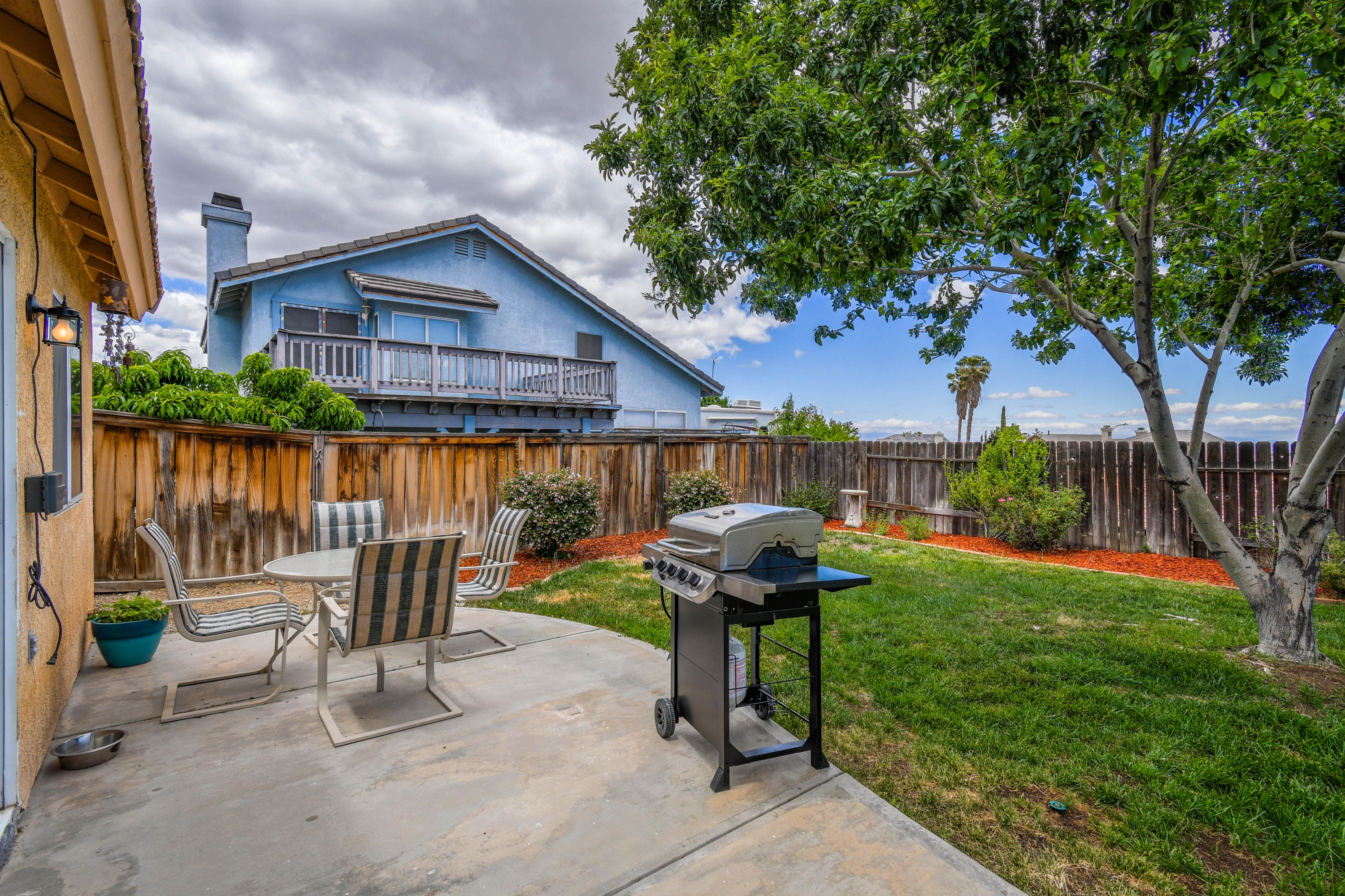 3129 Quarry Road Palmdale, CA 93550 - Photo 19 of 19 a view of a chair and table in backyard of the house