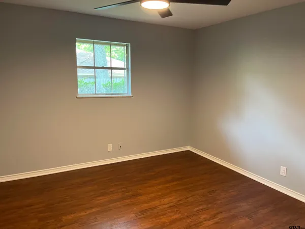 a view of a room with wooden floor and windows