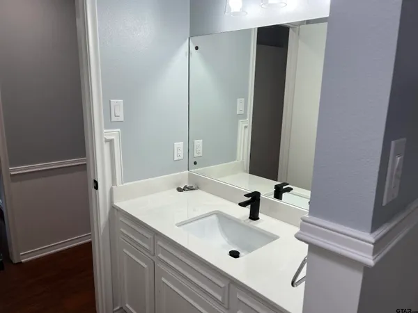 a bathroom with a sink and a mirror