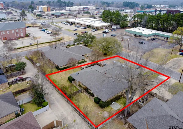 an aerial view of residential houses with outdoor space