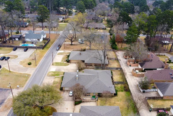 an aerial view of a house with a swimming pool