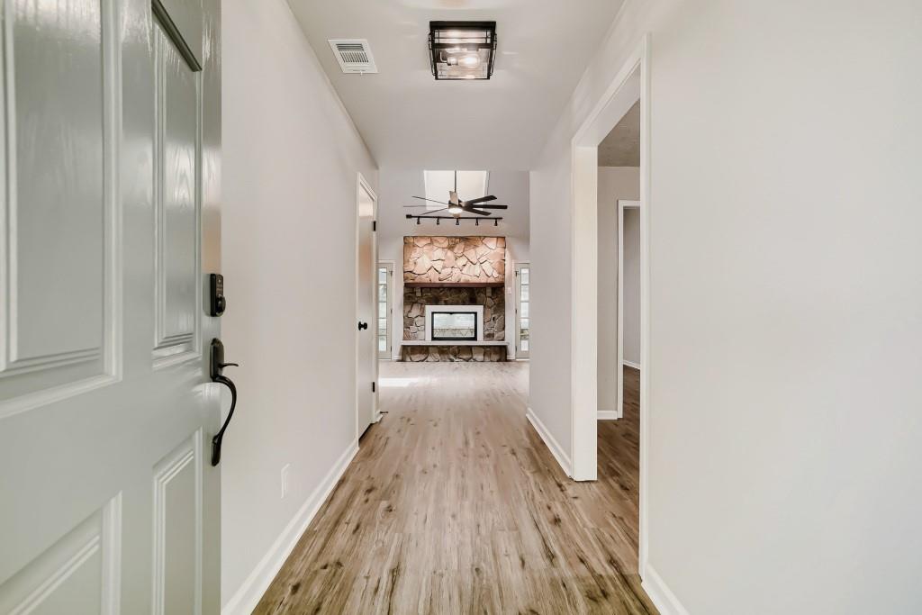 2021 Irwin Bridge Road Northwest Conyers, GA 30012 - Photo 7 of 43 a view of a hallway with wooden floor and staircase