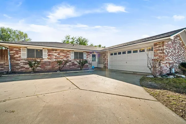 front view of house with potted plants