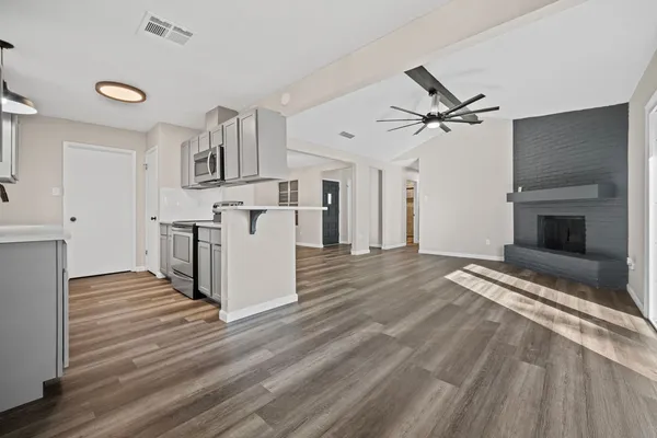 a view of a kitchen with a stove cabinets and wooden floor