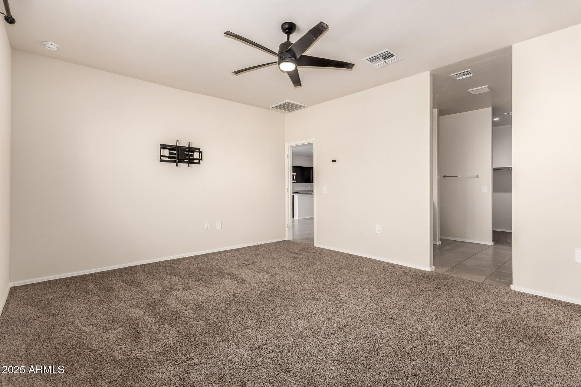 9458 Cotton Road Florence, AZ 85132 - Photo 15 of 30 an empty room with closet and a chandelier fan