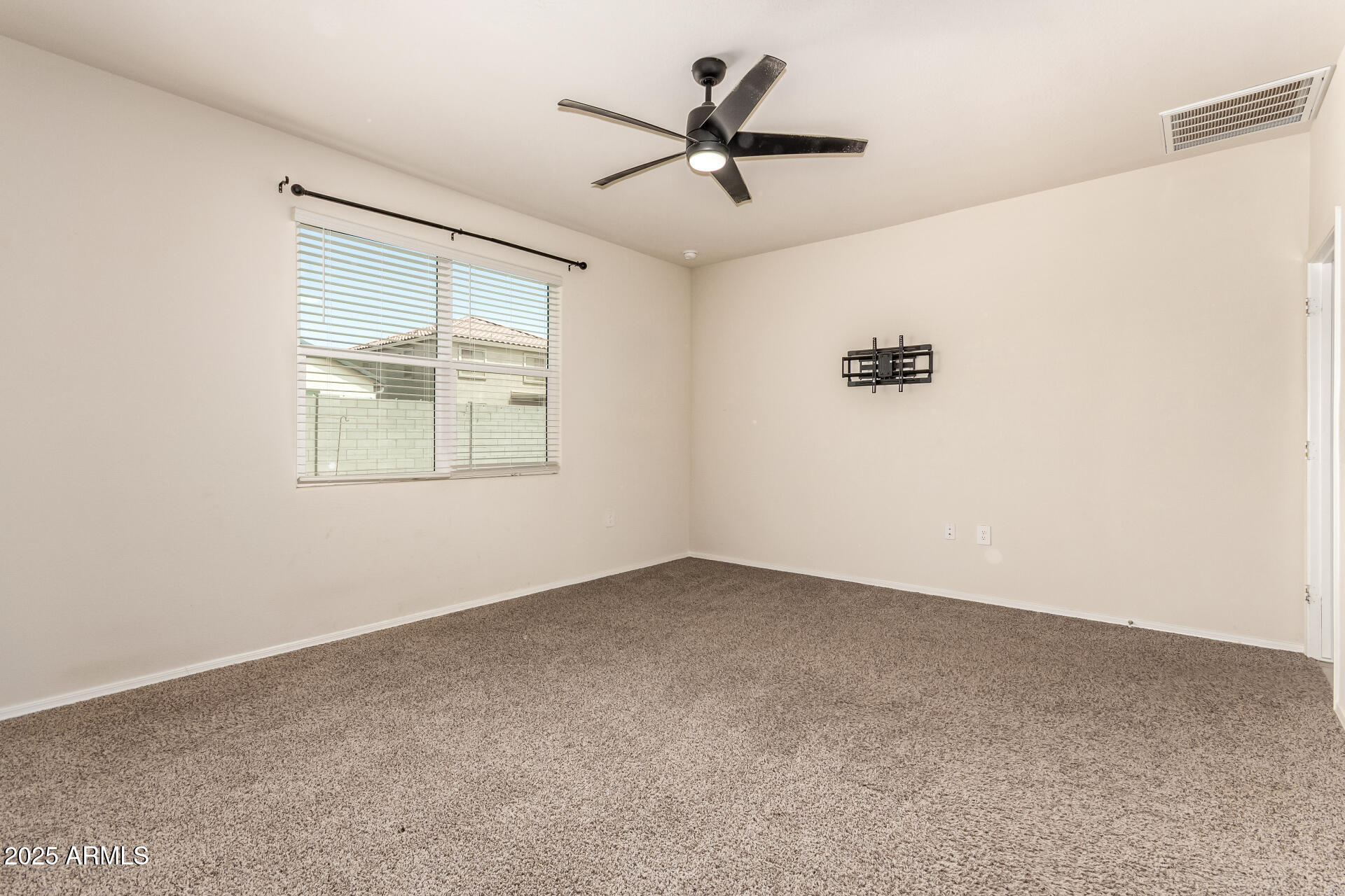 9458 Cotton Road Florence, AZ 85132 - Photo 16 of 30 an empty room with a window and a ceiling fan