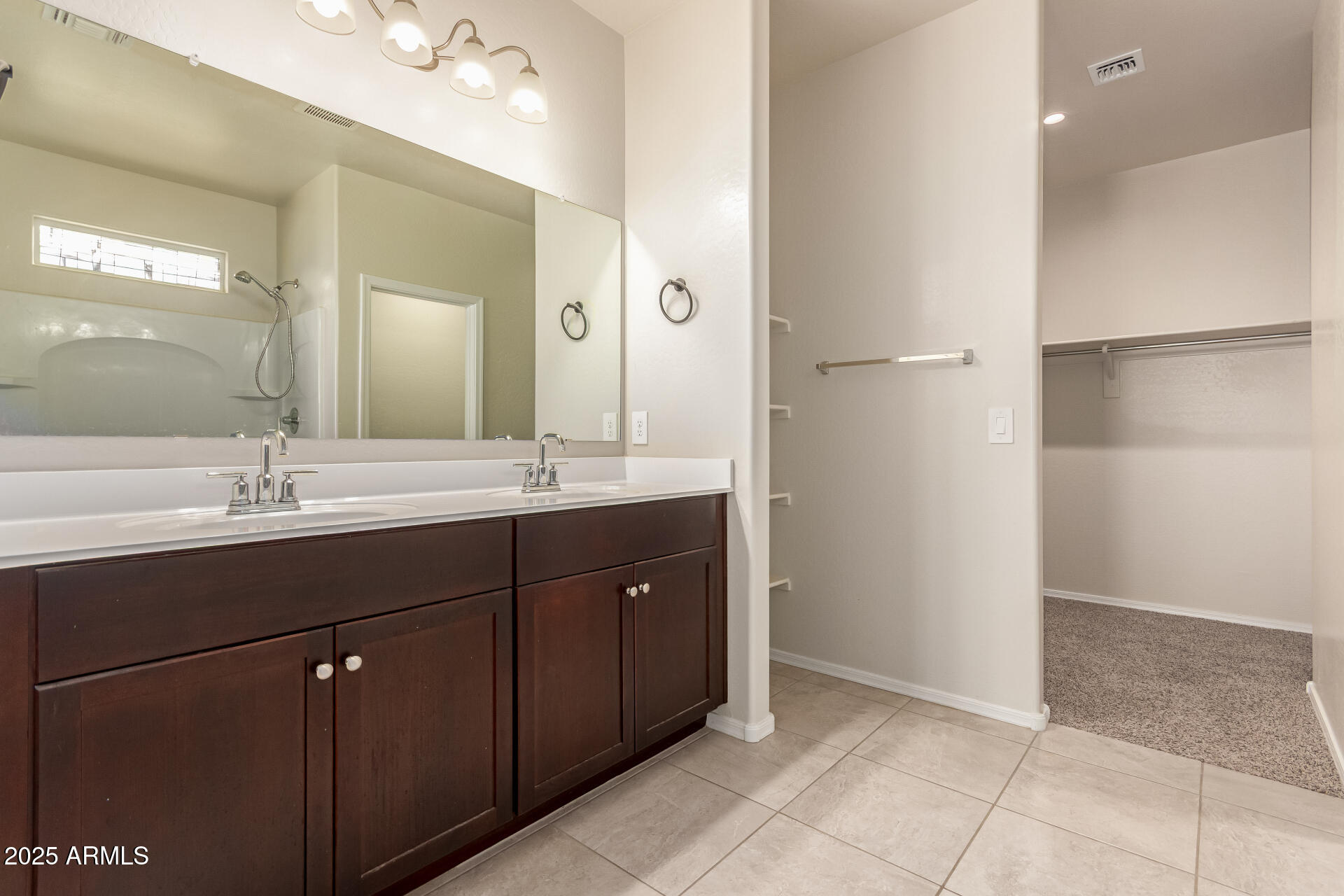 9458 Cotton Road Florence, AZ 85132 - Photo 17 of 30 a bathroom with a sink vanity and a mirror