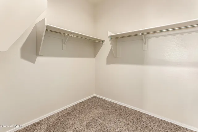 an empty room with a window and ceiling fan