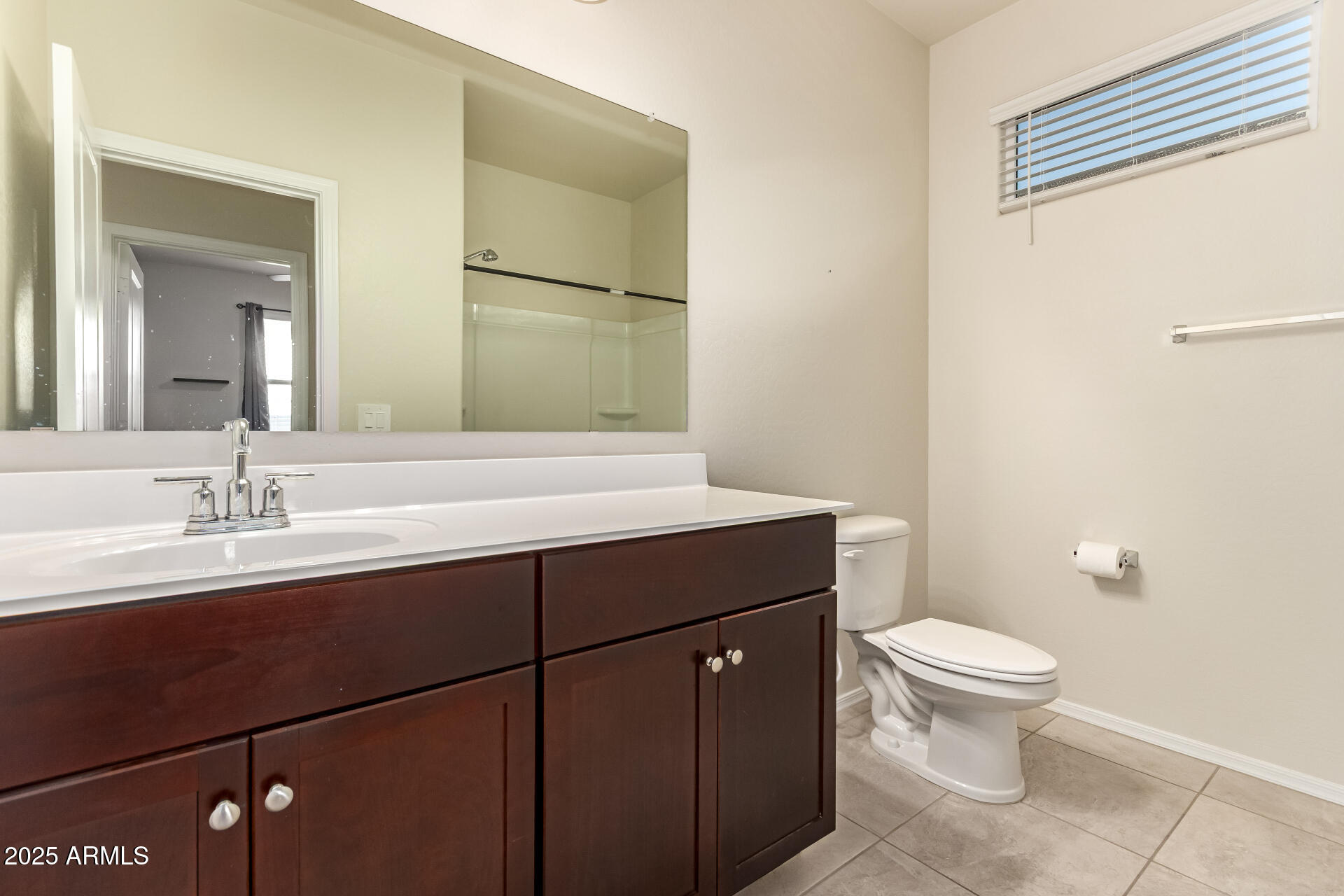 9458 Cotton Road Florence, AZ 85132 - Photo 22 of 30 a bathroom with a granite countertop sink a toilet and a mirror