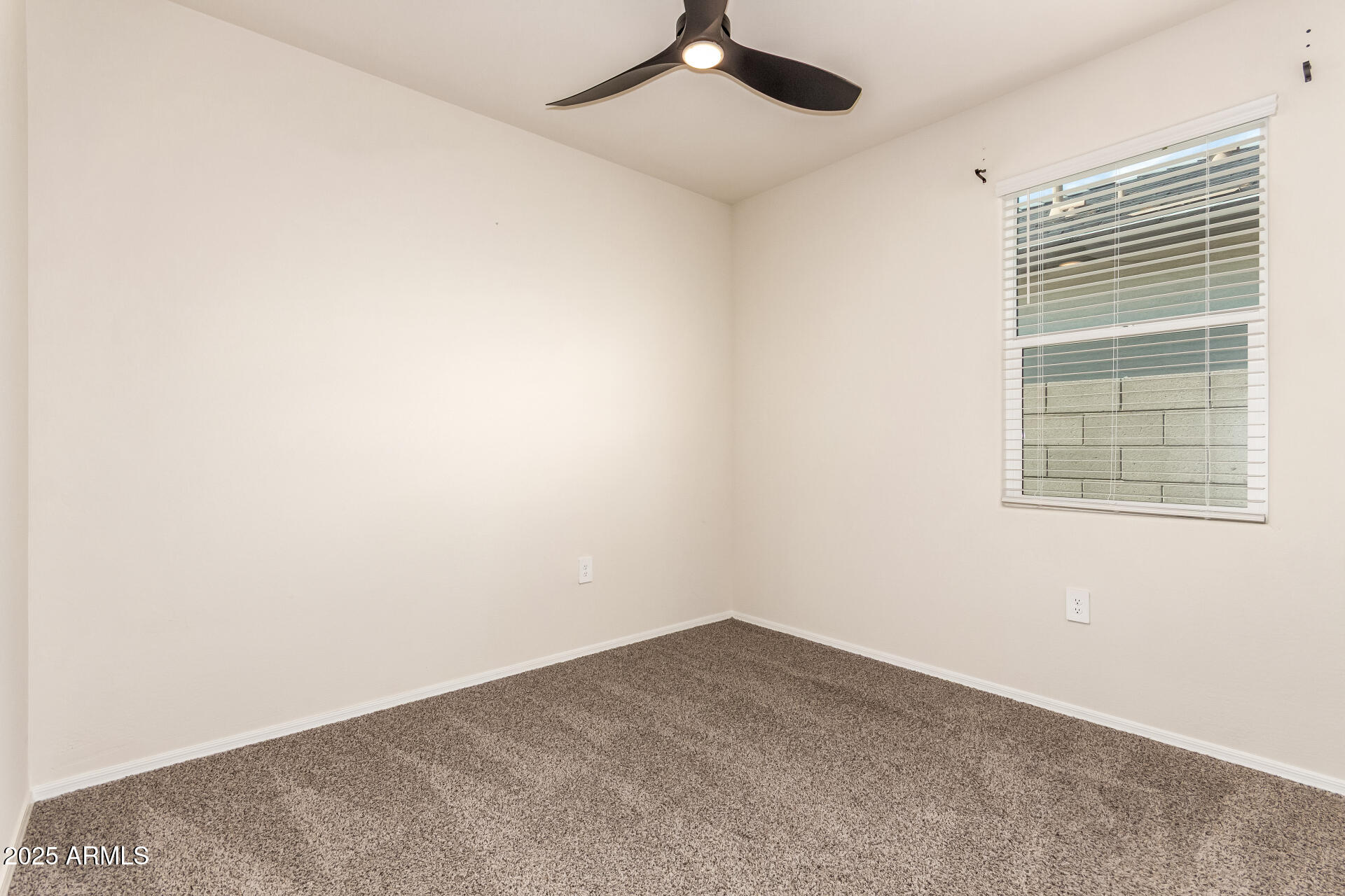 9458 Cotton Road Florence, AZ 85132 - Photo 23 of 30 an empty room with a window and a ceiling fan