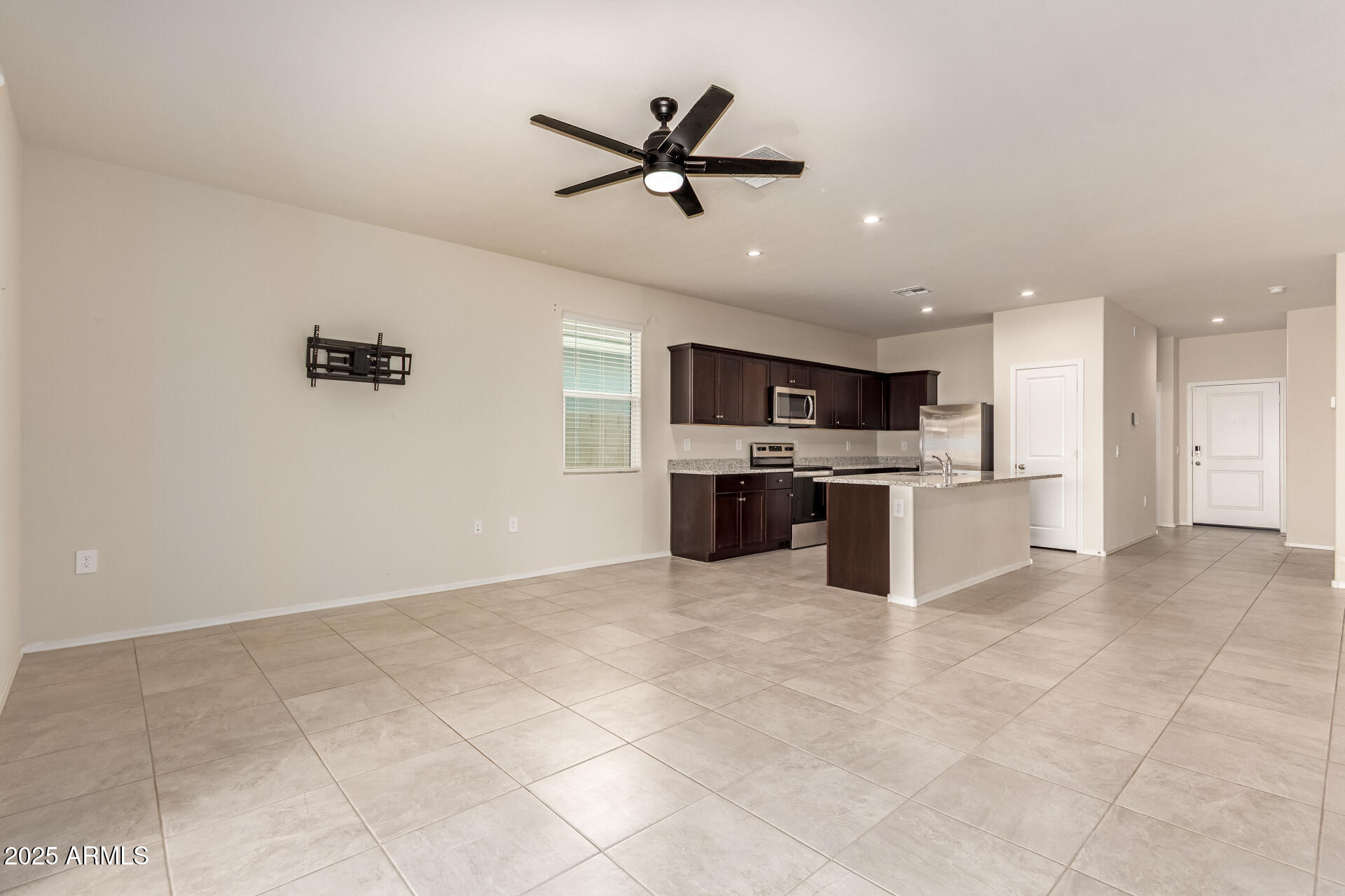 9458 Cotton Road Florence, AZ 85132 - Photo 4 of 30 a view of kitchen with stainless steel appliances kitchen island granite countertop refrigerator stove microwave and cabinets
