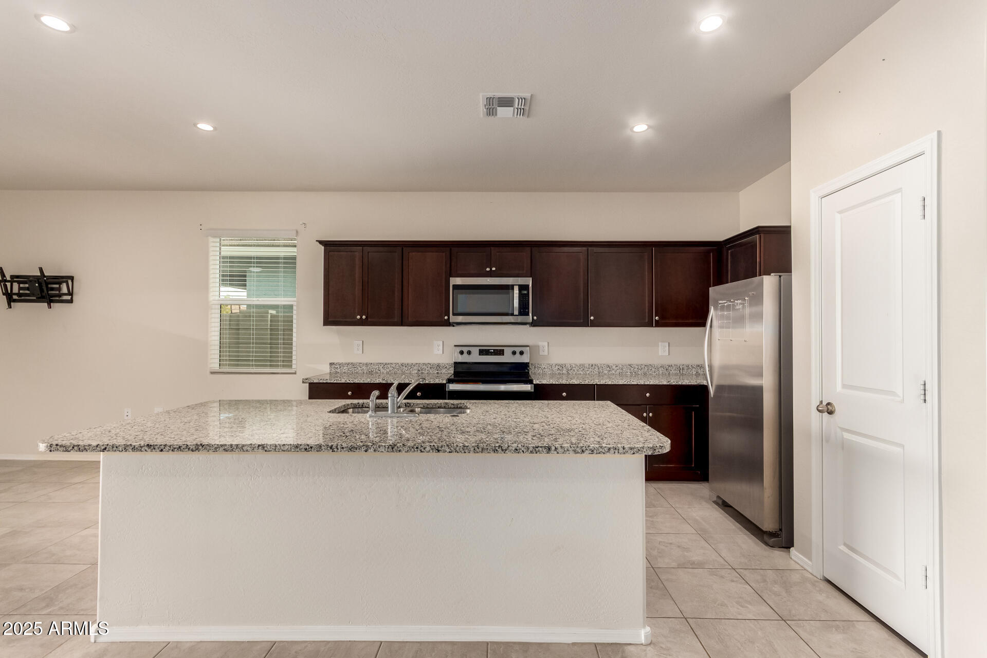 9458 Cotton Road Florence, AZ 85132 - Photo 5 of 30 a kitchen with stainless steel appliances granite countertop a refrigerator and a sink