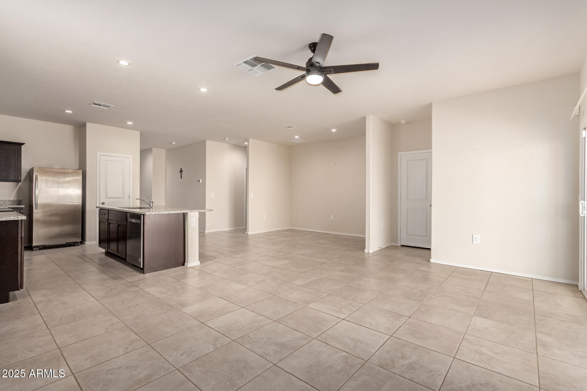 9458 Cotton Road Florence, AZ 85132 - Photo 6 of 30 a view of a kitchen with a sink and a refrigerator