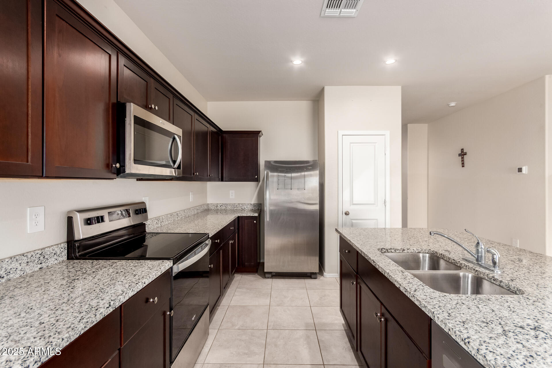 9458 Cotton Road Florence, AZ 85132 - Photo 7 of 30 a kitchen with stainless steel appliances granite countertop a sink stove and refrigerator