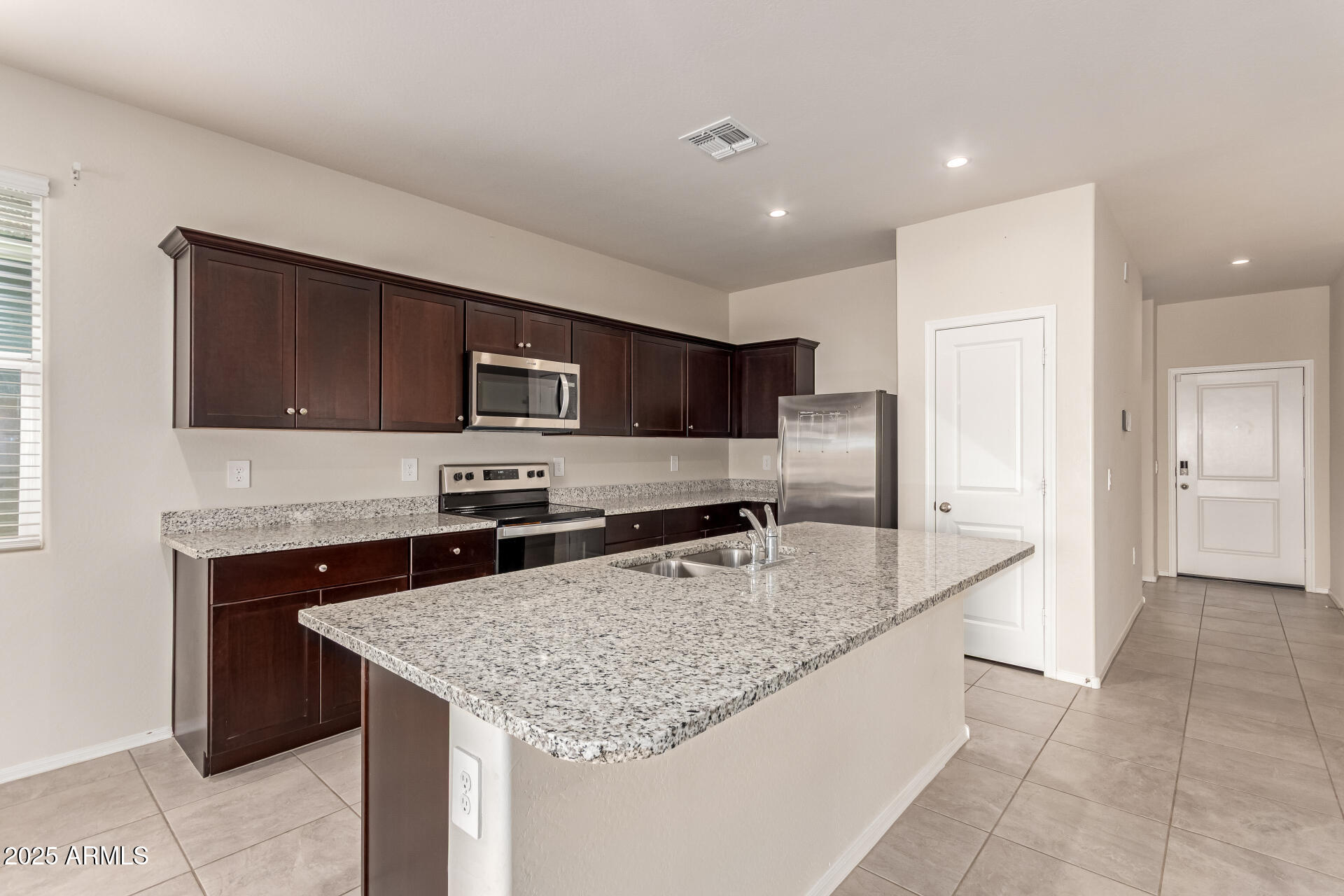 9458 Cotton Road Florence, AZ 85132 - Photo 8 of 30 a kitchen with stainless steel appliances granite countertop a sink and a microwave