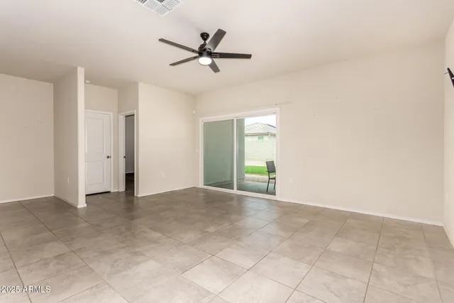 a view of a livingroom with a ceiling fan and carpet