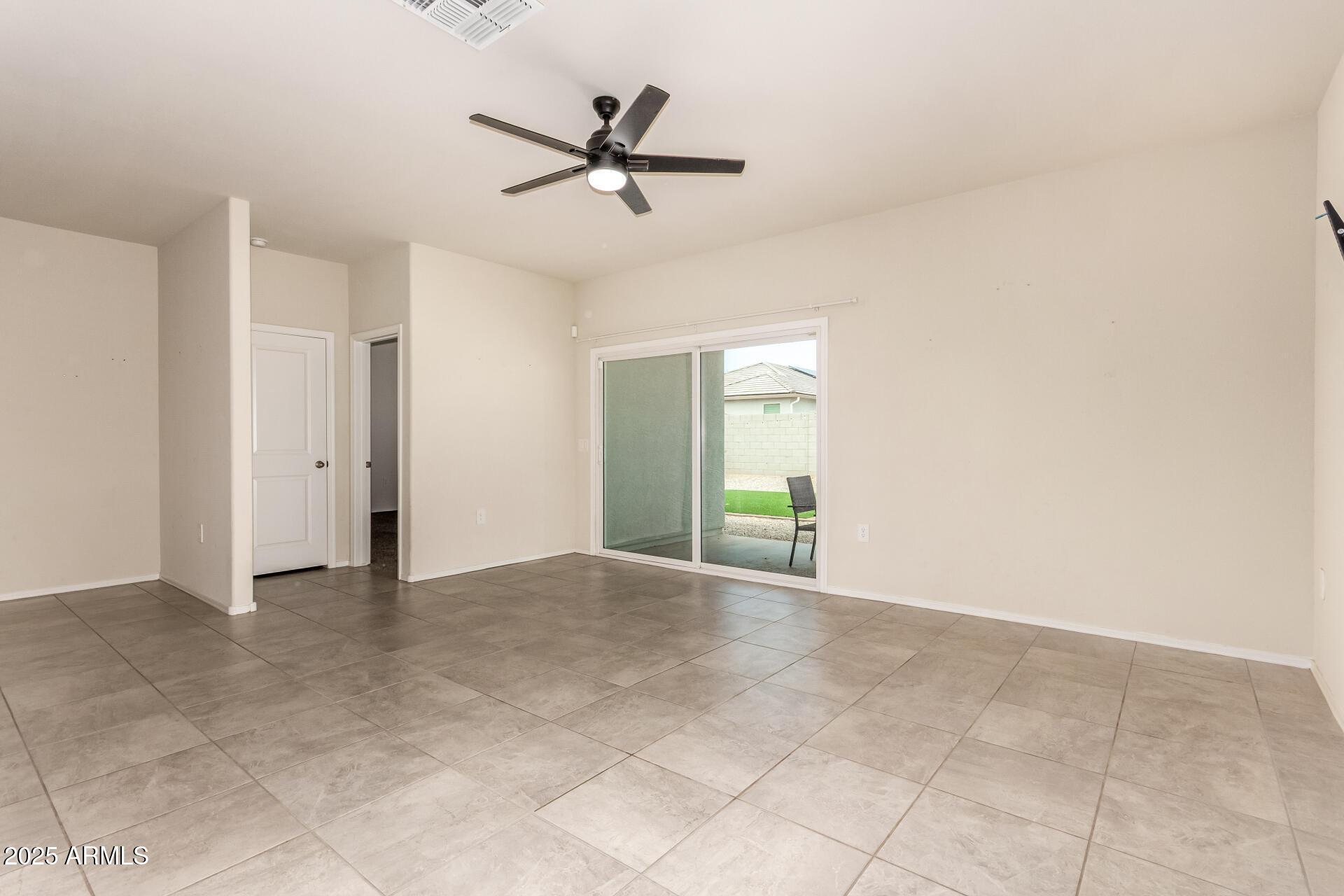 9458 Cotton Road Florence, AZ 85132 - Photo 10 of 30 a view of a livingroom with a ceiling fan and carpet