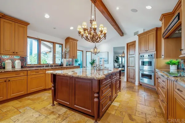 a kitchen with stainless steel appliances granite countertop a stove and more cabinets